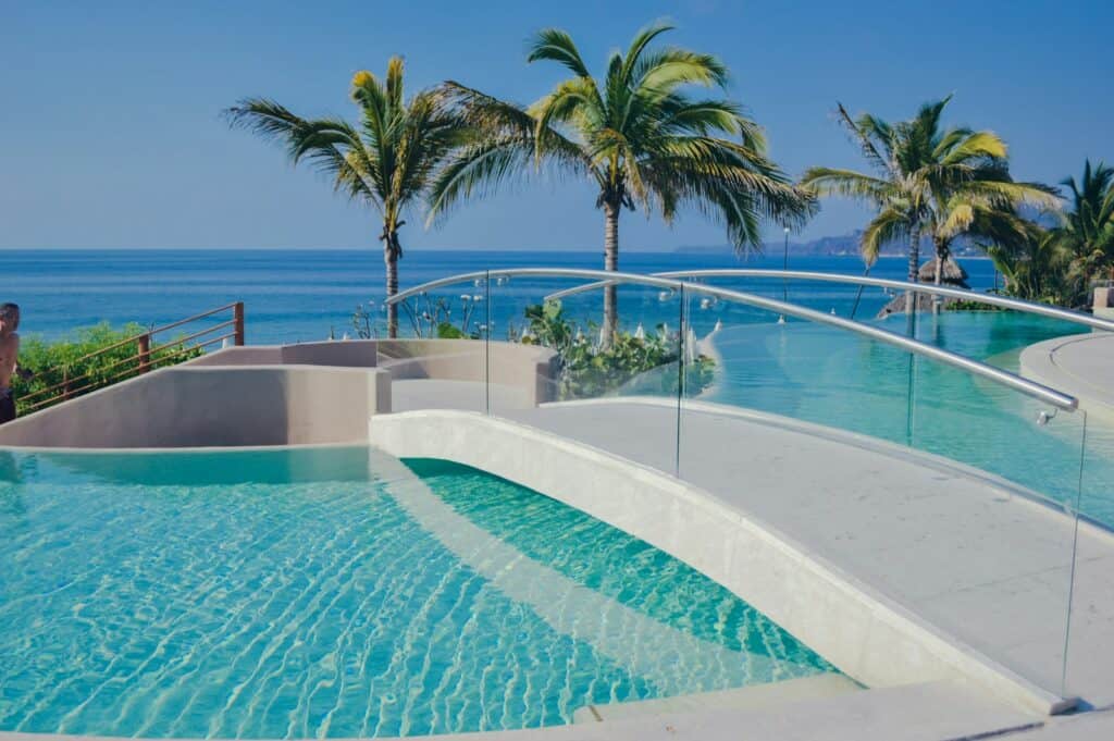 swimming pool near palm tree during daytime